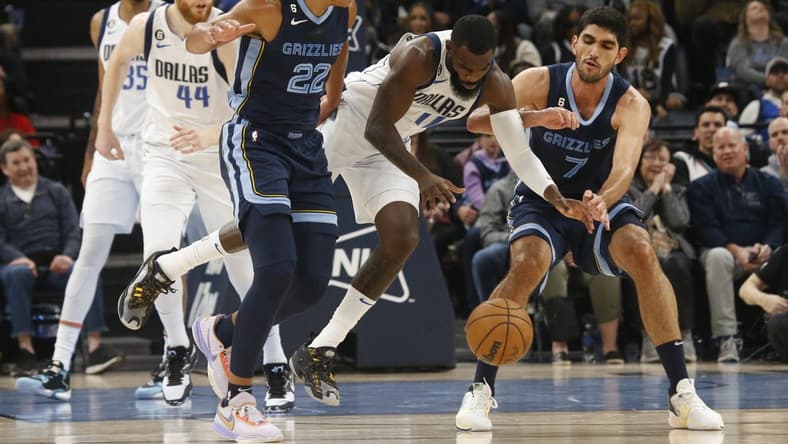 Mar 11, 2023; Memphis, Tennessee, USA; Dallas Mavericks forward Tim Hardaway Jr. (11) fights between Memphis Grizzlies guard Desmond Bane (22) and forward Santi Aldama (7) for a loose ball during the first half at FedExForum. Mandatory Credit: Petre Thomas-USA TODAY Sports