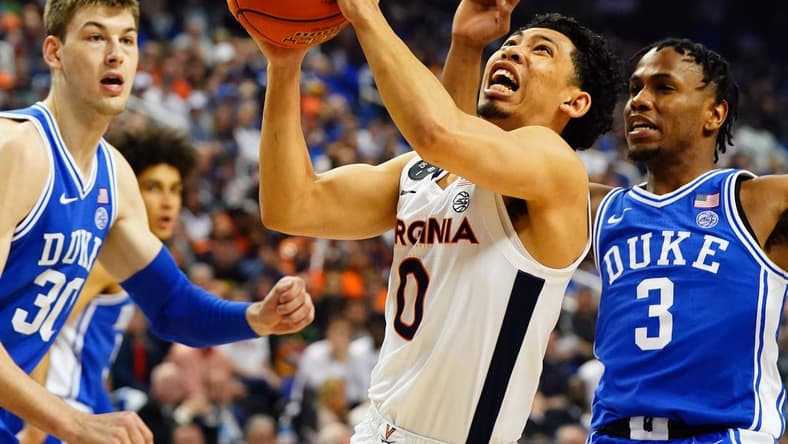 Mar 11, 2023; Greensboro, NC, USA; Virginia Cavaliers guard Kihei Clark (0) drives to the basket against Duke Blue Devils center Kyle Filipowski (30) and guard Jeremy Roach (3) during the first half of the ACC Championship at Greensboro Coliseum. Mandatory Credit: John David Mercer-USA TODAY Sports