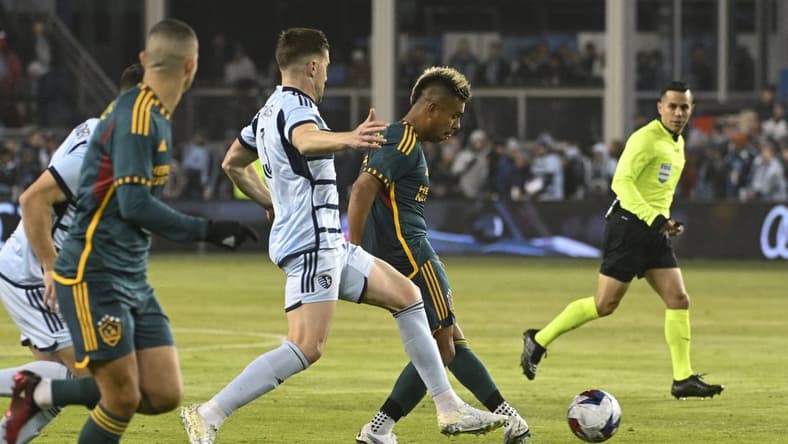 Mar 11, 2023; Kansas City, Kansas, USA; Sporting Kansas City defender Andreu Fontas (3) and Los Angeles Galaxy midfielder Efrain Alvares (7) battle for control of the ball at Children's Mercy Park. Mandatory Credit: Joe Puetz-USA TODAY Sports