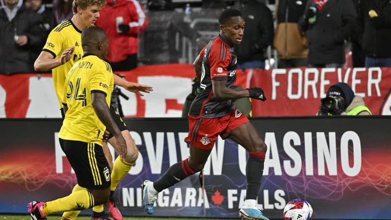 Mar 11, 2023; Toronto, Ontario, CAN; Toronto FC midfielder Richie Laryea (22) controls the ball against Columbus Crew defender Philip Quinton (2) and Columbus Crew midfielder Jimmy Medranda (94) in the second half in a MLS game at BMO Field. Mandatory Credit: Dan Hamilton-USA TODAY Sports