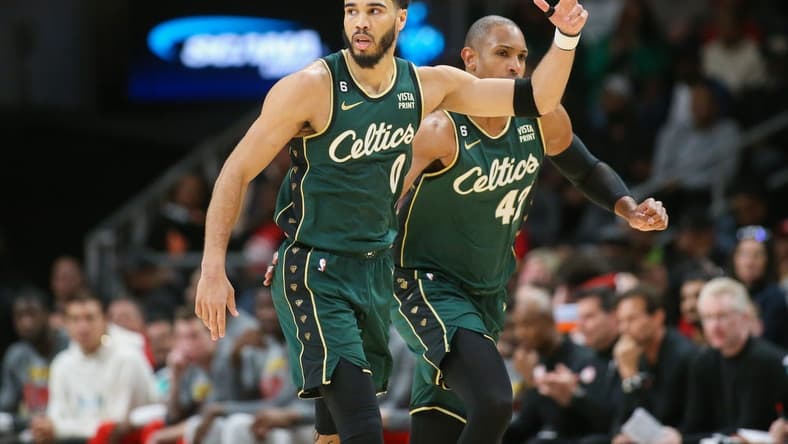 Mar 11, 2023; Atlanta, Georgia, USA; Boston Celtics forward Jayson Tatum (0) reacts after a three-pointer as center Al Horford (42) looks on against the Atlanta Hawks in the second half at State Farm Arena. Mandatory Credit: Brett Davis-USA TODAY Sports