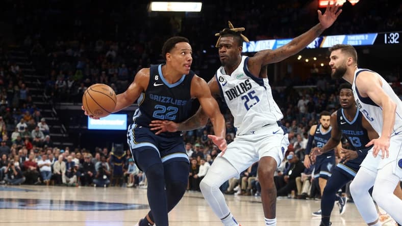 Mar 11, 2023; Memphis, Tennessee, USA; Memphis Grizzlies guard Desmond Bane (22) drives to the basket as Dallas Mavericks forward Reggie Bullock (25) defends during the second half at FedExForum. Mandatory Credit: Petre Thomas-USA TODAY Sports