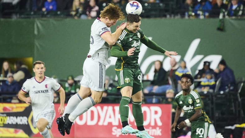 Mar 11, 2023; Portland, Oregon, USA;  Portland Timbers forward Nathan Fogaca (99) heads the ball during the first half against St. Louis City defender Tim Parker (26) at Providence Park. Mandatory Credit: Troy Wayrynen-USA TODAY Sports