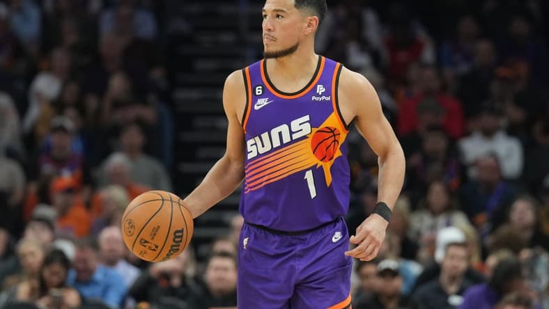 Mar 11, 2023; Phoenix, Arizona, USA; Phoenix Suns guard Devin Booker (1) dribbles against the Sacramento Kings during the second half at Footprint Center. Mandatory Credit: Joe Camporeale-USA TODAY Sports