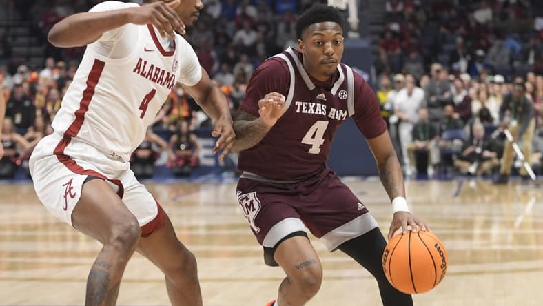 Mar 12, 2023; Nashville, TN, USA; Texas A&M Aggies guard Wade Taylor IV (4) dribbles past Alabama Crimson Tide forward Noah Gurley (4) during the first half at Bridgestone Arena. Mandatory Credit: Steve Roberts-USA TODAY Sports