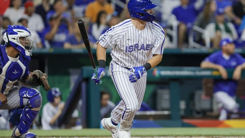 Mar 12, 2023; Miami, Florida, USA; Israel designated hitter Spencer Horwitz (4) hits an RBI single during the eighth inning against Nicaragua at LoanDepot Park. Mandatory Credit: Sam Navarro-USA TODAY Sports