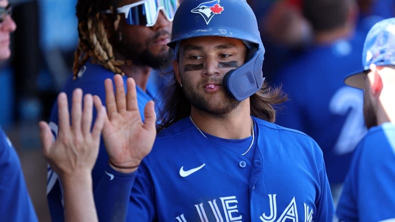 Mar 12, 2023; Clearwater, Florida, USA; Toronto Blue Jays shortstop Bo Bichette (11) scores a run against the Philadelphia Phillies during the fourth inning at BayCare Ballpark. Mandatory Credit: Kim Klement-USA TODAY Sports