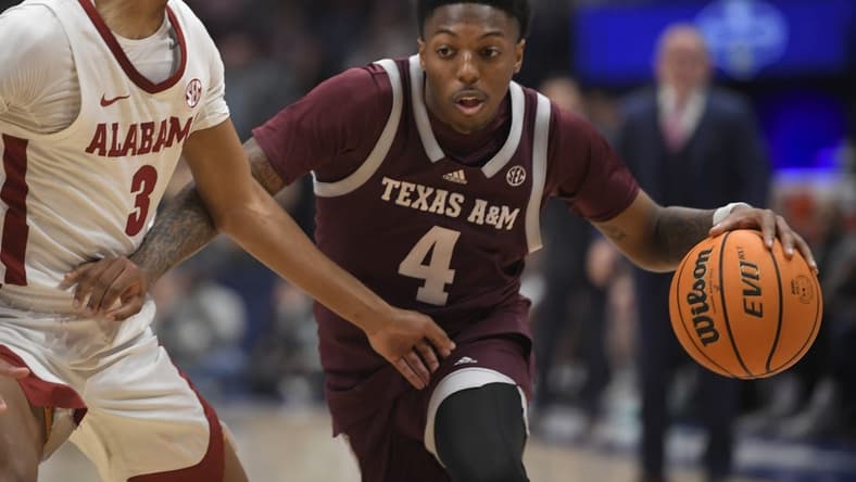 Mar 12, 2023; Nashville, TN, USA; Texas A&M Aggies guard Wade Taylor IV (4) dribbles past Alabama Crimson Tide guard Rylan Griffen (3) during the first half at Bridgestone Arena. Mandatory Credit: Steve Roberts-USA TODAY Sports