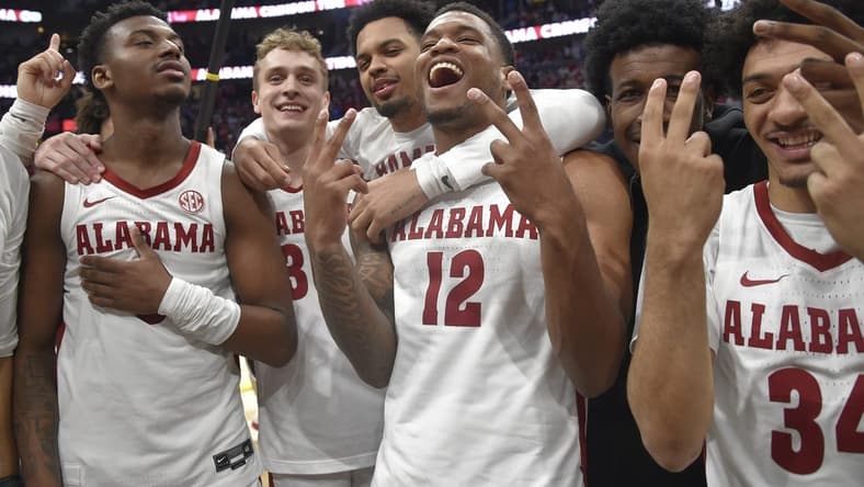 Mar 12, 2023; Nashville, TN, USA;  Alabama Crimson Tide guard Jaden Bradley (0), center Charles Bediako (14), guard Jahvon Quinerly (5), guard Adam Cottrell (30), guard Delaney Heard (12), and guard Rylan Griffen (3) celebrate the win against the Texas A&M Aggies during the second half at Bridgestone Arena. Mandatory Credit: Steve Roberts-USA TODAY Sports