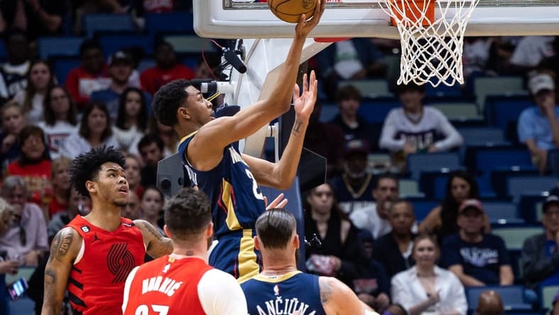 Mar 12, 2023; New Orleans, Louisiana, USA; New Orleans Pelicans guard Trey Murphy III (25) drives to the basket against Portland Trail Blazers center Jusuf Nurkic (27) during the first half at Smoothie King Center. Mandatory Credit: Stephen Lew-USA TODAY Sports