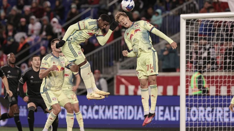 Mar 4, 2023; Harrison, New Jersey, USA; New York Red Bulls forward Tom Barlow (74) heads the ball in front of defender Andres Reyes (4) during the first half against the Nashville SC at Red Bull Arena. Mandatory Credit: Vincent Carchietta-USA TODAY Sports