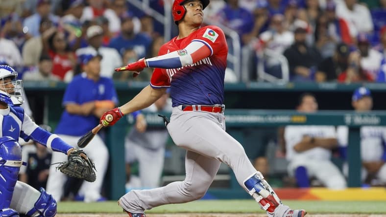 Mar 13, 2023; Miami, Florida, USA; Dominican Republic left fielder Juan Soto (22) hits a home run during the sixth inning against Nicaragua at LoanDepot Park. Mandatory Credit: Sam Navarro-USA TODAY Sports