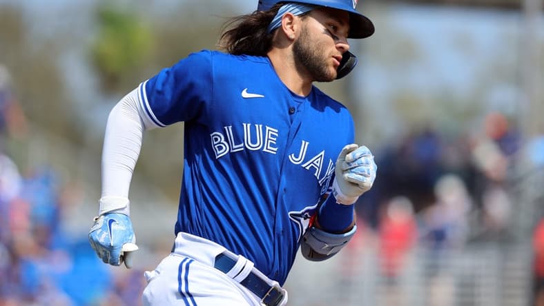 Mar 13, 2023; Dunedin, Florida, USA; Toronto Blue Jays shortstop Bo Bichette (11) hits a home run against the Boston Red Sox during the fourth inning at TD Ballpark. Mandatory Credit: Kim Klement-USA TODAY Sports