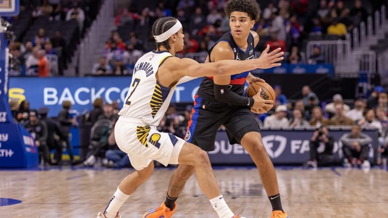 Mar 13, 2023; Detroit, Michigan, USA; Detroit Pistons guard Killian Hayes (7) controls the ball in front of Indiana Pacers guard Andrew Nembhard (2) during the first quarter at Little Caesars Arena. Mandatory Credit: David Reginek-USA TODAY Sports