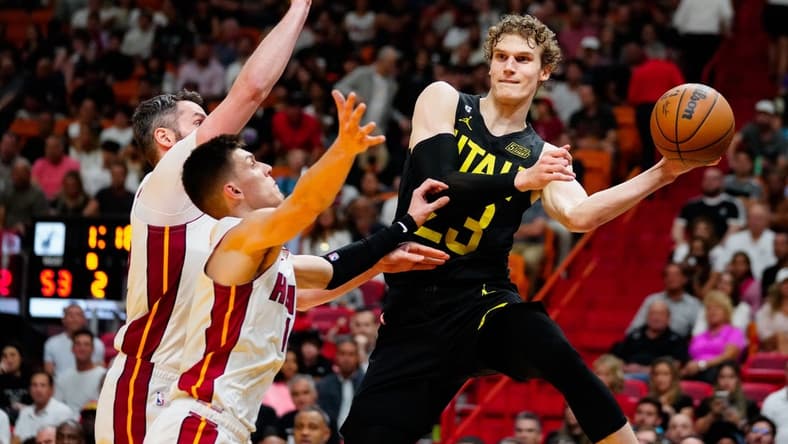 Mar 13, 2023; Miami, Florida, USA; Utah Jazz forward Lauri Markkanen (23) throws a pass as Miami Heat guard Tyler Herro (14) defends during the second quarter at Miami-Dade Arena. Mandatory Credit: Rich Storry-USA TODAY Sports