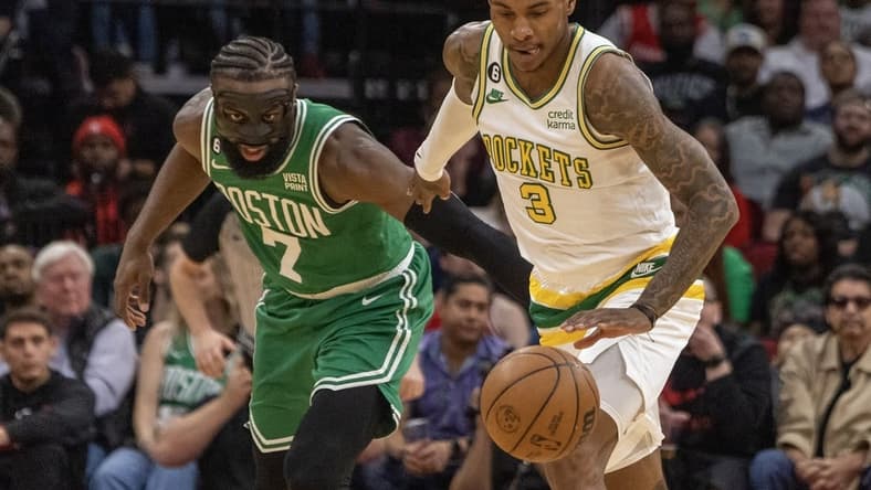 Mar 13, 2023; Houston, Texas, USA; Houston Rockets guard Kevin Porter Jr. (3) dribbles against Boston Celtics guard Jaylen Brown (7) in the second quarter at Toyota Center. Mandatory Credit: Thomas Shea-USA TODAY Sports