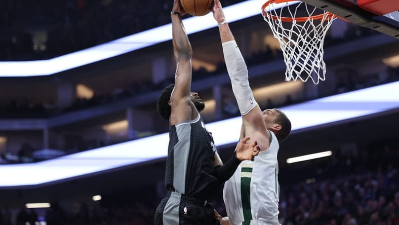 Mar 13, 2023; Sacramento, California, USA; Milwaukee Bucks center Brook Lopez (11) blocks the shot of Sacramento Kings power forward Chimezie Metu (7) during the first quarter at Golden 1 Center. Mandatory Credit: Kelley L Cox-USA TODAY Sports