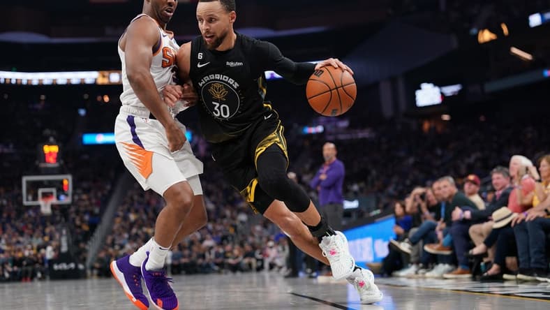Mar 13, 2023; San Francisco, California, USA; Golden State Warriors guard Stephen Curry (30) dribbles the ball next to Phoenix Suns guard Chris Paul (3) in the second quarter at the Chase Center. Mandatory Credit: Cary Edmondson-USA TODAY Sports