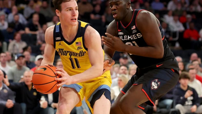 Mar 10, 2023; New York, NY, USA; Marquette Golden Eagles guard Tyler Kolek (11) controls the ball against Connecticut Huskies forward Adama Sanogo (21) during the second half at Madison Square Garden. Mandatory Credit: Brad Penner-USA TODAY Sports