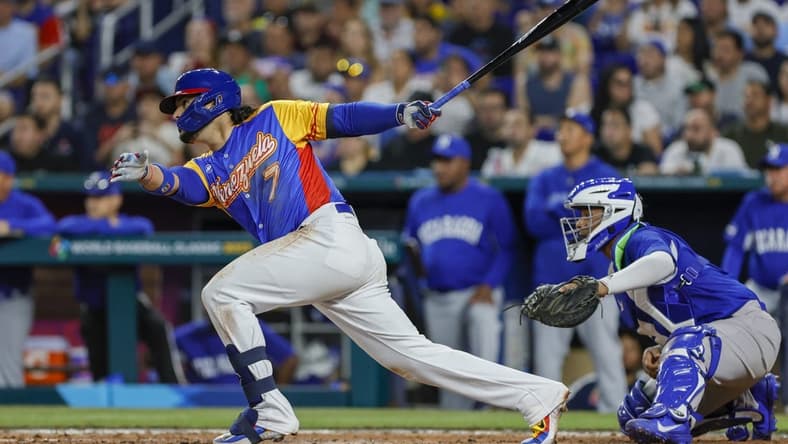 Mar 14, 2023; Miami, Florida, USA; Venezuela third baseman Eugenio Suarez (7) hits a two-run single during the fourth inning against Nicaragua at LoanDepot Park. Mandatory Credit: Sam Navarro-USA TODAY Sports