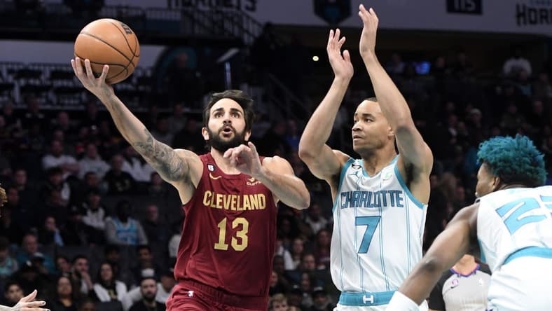 Mar 14, 2023; Charlotte, North Carolina, USA; Cleveland Cavaliers guard Ricky Rubio (13) drives past Charlotte Hornets guard Bryce McGowens (7) during the first half at the Spectrum Center. Mandatory Credit: Sam Sharpe-USA TODAY Sports