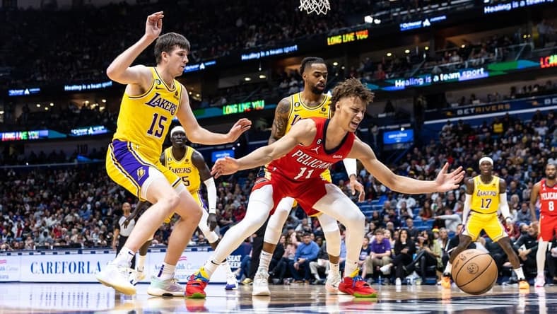 Mar 14, 2023; New Orleans, Louisiana, USA; New Orleans Pelicans guard Dyson Daniels (11) looses the ball out of bounds against Los Angeles Lakers guard Austin Reaves (15) during the first half at Smoothie King Center. Mandatory Credit: Stephen Lew-USA TODAY Sports
