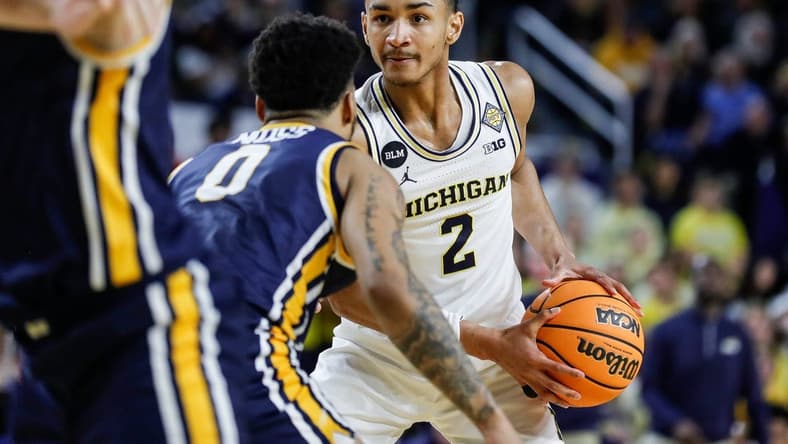 Michigan guard Kobe Bufkin (2) looks to pass against Toledo guard Ra'Heim Moss (0) during the second half of the first round of the NIT at Crisler Center in Ann Arbor on Tuesday, March 14, 2023.