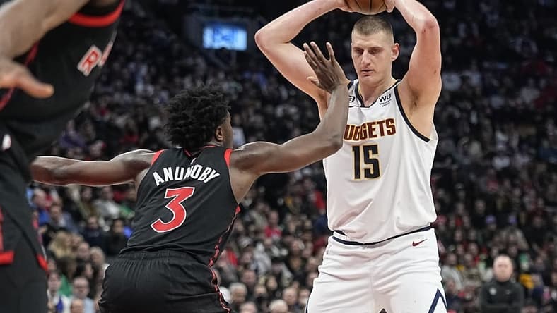 Mar 14, 2023; Toronto, Ontario, CAN; Toronto Raptors forward O.G. Anunoby (3) defends against Denver Nuggets center Nikola Jokic (15) during the second half at Scotiabank Arena. Mandatory Credit: John E. Sokolowski-USA TODAY Sports