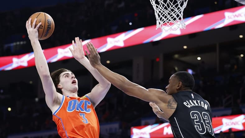 Mar 14, 2023; Oklahoma City, Oklahoma, USA; Oklahoma City Thunder guard Josh Giddey (3) shoots as Brooklyn Nets center Nic Claxton (33) defends the shot during the second half at Paycom Center. Oklahoma City won 121-107. Mandatory Credit: Alonzo Adams-USA TODAY Sports