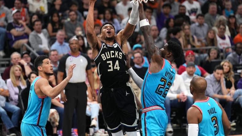Mar 14, 2023; Phoenix, Arizona, USA; Milwaukee Bucks forward Giannis Antetokounmpo (34) shoots over Phoenix Suns center Deandre Ayton (22) during the first half at Footprint Center. Mandatory Credit: Joe Camporeale-USA TODAY Sports