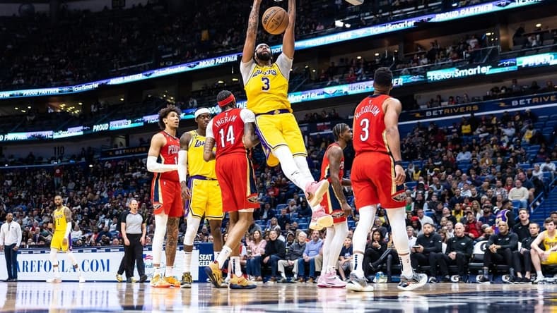 Mar 14, 2023; New Orleans, Louisiana, USA; Los Angeles Lakers forward Anthony Davis (3) dunks the ball against New Orleans Pelicans forward Brandon Ingram (14) during the second half at Smoothie King Center. Mandatory Credit: Stephen Lew-USA TODAY Sports