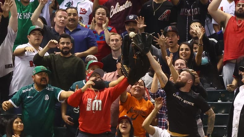 Mar 14, 2023; Phoenix, Arizona, USA; A Mexico fan in the crowd catches a ball with an oversized glove in the fourth inning against Great Britain during the World Baseball Classic at Chase Field. Mandatory Credit: Mark J. Rebilas-USA TODAY Sports