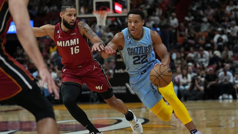 Mar 15, 2023; Miami, Florida, USA; Memphis Grizzlies guard Desmond Bane (22) drives to the basket as Miami Heat forward Caleb Martin (16) defends in the first half at Miami-Dade Arena. Mandatory Credit: Jim Rassol-USA TODAY Sports