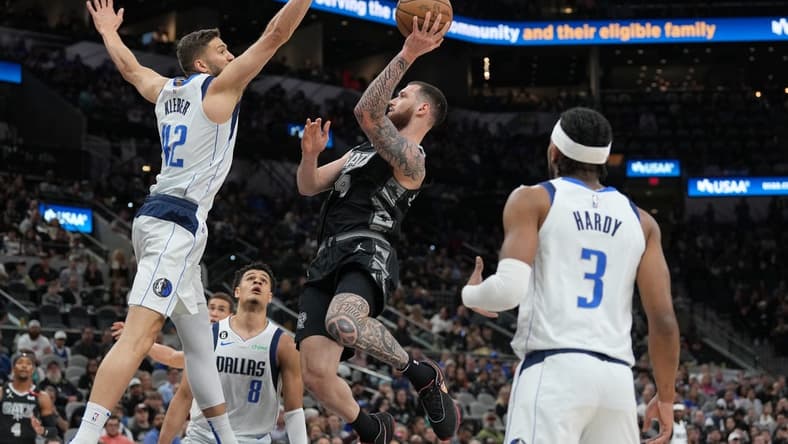 Mar 15, 2023; San Antonio, Texas, USA; San Antonio Spurs forward Sandro Mamukelashvili (54) shoots in front of Dallas Mavericks forward Maxi Kleber (42) in the first half at the AT&T Center. Mandatory Credit: Daniel Dunn-USA TODAY Sports