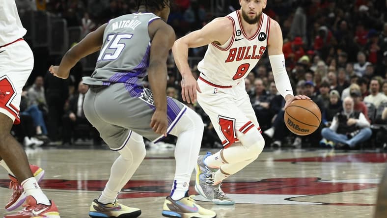 Mar 15, 2023; Chicago, Illinois, USA; Chicago Bulls guard Zach LaVine (8) moves the ball past Sacramento Kings guard Davion Mitchell (15) during the first half at the United Center. Mandatory Credit: Matt Marton-USA TODAY Sports