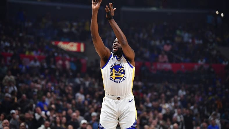 Mar 15, 2023; Los Angeles, California, USA; Golden State Warriors forward Draymond Green (23) shoots against the Los Angeles Clippers during the first half at Crypto.com Arena. Mandatory Credit: Gary A. Vasquez-USA TODAY Sports