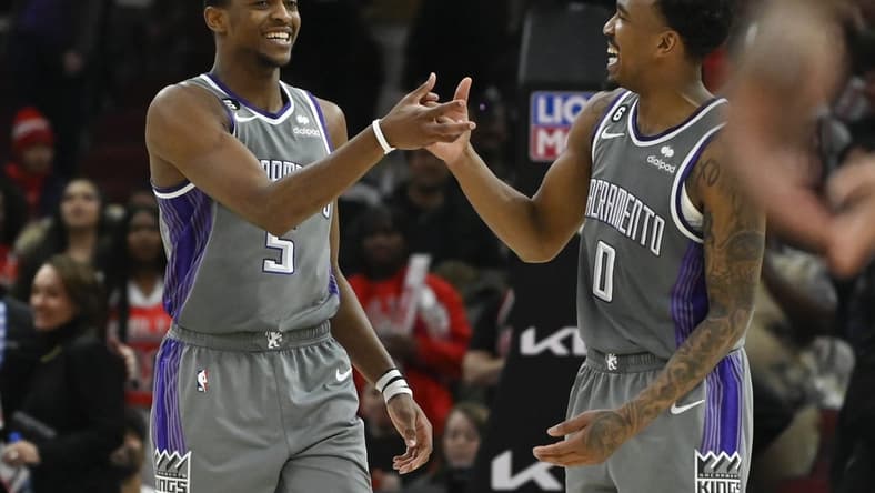Mar 15, 2023; Chicago, Illinois, USA; Sacramento Kings guard De'Aaron Fox (5) celebrates with guard Malik Monk (0) after Fox made a three-point basket to defeat the Chicago Bulls at the United Center. Mandatory Credit: Matt Marton-USA TODAY Sports