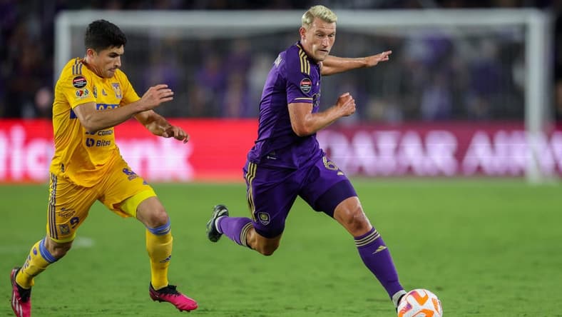 Mar 15, 2023; Orlando, FL, USA; Tigres UANL forward Nicolas Ibanez (9) and Orlando City SC defender Robin Jansson (6) battle for the ball in the second half during the CONCACAF Champions League at Exploria Stadium. Mandatory Credit: Nathan Ray Seebeck-USA TODAY Sports