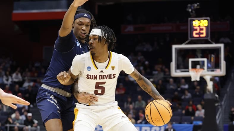 Mar 15, 2023; Dayton, OH, USA; Arizona State Sun Devils forward Jamiya Neal (5) dribbles the ball defend by Nevada Wolf Pack forward Tre Coleman (14) in the second half at UD Arena. Mandatory Credit: Rick Osentoski-USA TODAY Sports