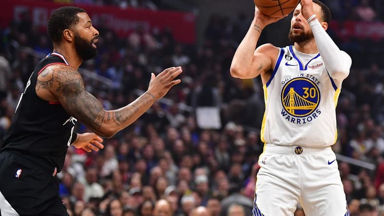 Mar 15, 2023; Los Angeles, California, USA; Golden State Warriors guard Stephen Curry (30) shoots against Los Angeles Clippers forward Marcus Morris Sr. (8) during the first half at Crypto.com Arena. Mandatory Credit: Gary A. Vasquez-USA TODAY Sports