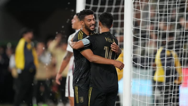 Mar 15, 2023; Los Angeles, CA, USA; LAFC forward Carlos Vela (10) celebrates with forward Denis Bouanga (99) after scoring a goal against the Alajuelense in the second half at BMO Stadium. Mandatory Credit: Kirby Lee-USA TODAY Sports