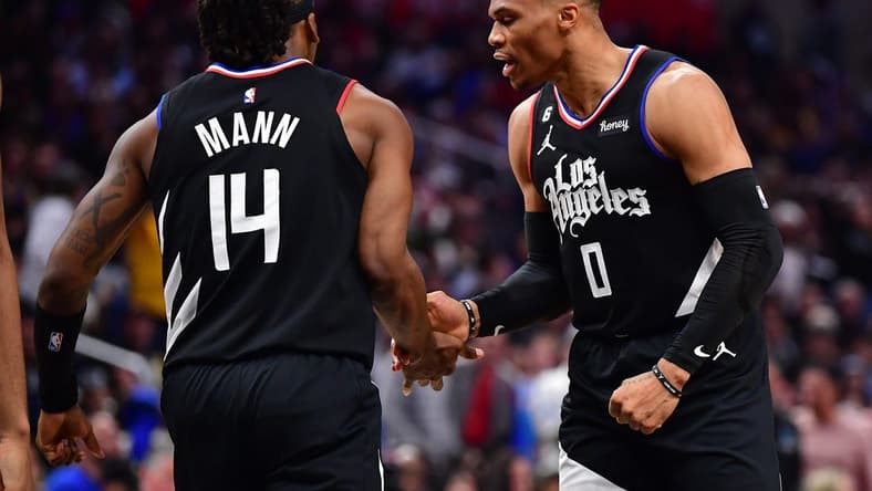 Mar 15, 2023; Los Angeles, California, USA; Los Angeles Clippers guard Russell Westbrook (0) reacts after guard Terance Mann (14) scores a basket and draws the foul against the Golden State Warriors during the second half at Crypto.com Arena. Mandatory Credit: Gary A. Vasquez-USA TODAY Sports