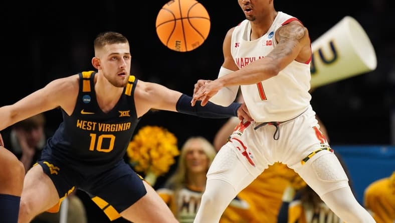 Mar 16, 2023; Birmingham, AL, USA; Maryland Terrapins guard Jahmir Young (1) passes the ball away from West Virginia Mountaineers guard Erik Stevenson (10) during the first half in the first round of the 2023 NCAA Tournament at Legacy Arena. Mandatory Credit: Marvin Gentry-USA TODAY Sports