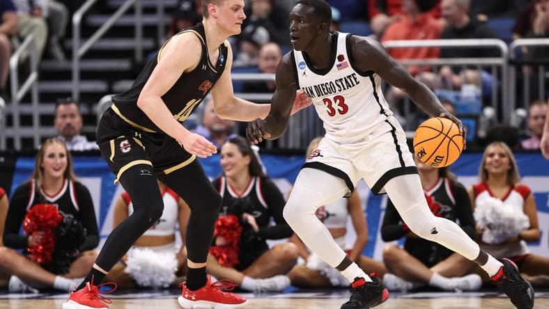 Mar 16, 2023; Orlando, FL, USA; San Diego State Aztecs forward Aguek Arop (33) dribbles the ball while defended by College of Charleston Cougars forward Ante Brzovic (10) during the second half at Amway Center. Mandatory Credit: Matt Pendleton-USA TODAY Sports