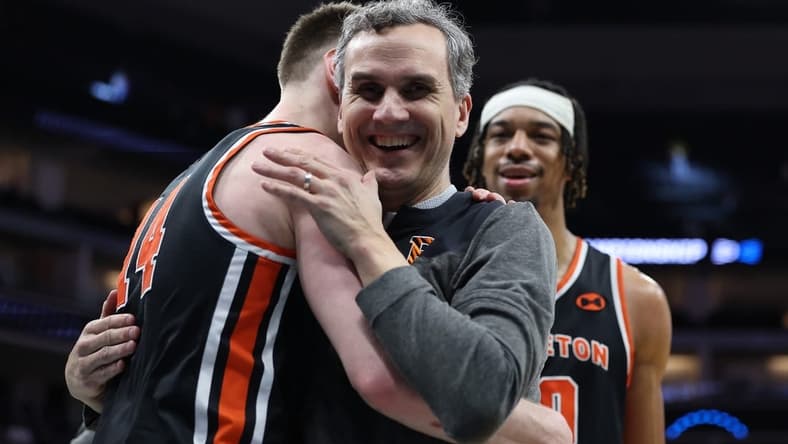 Mar 16, 2023; Sacramento, CA, USA; Princeton Tigers head coach Mitch Henderson celebrates the victory against the Arizona Wildcats with guard Matt Allocco (14) at Golden 1 Center. Mandatory Credit: Kelley L Cox-USA TODAY Sports