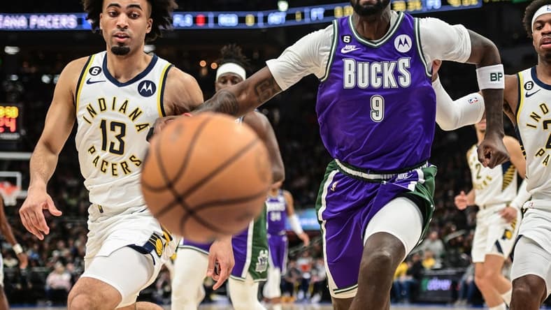Mar 16, 2023; Milwaukee, Wisconsin, USA; Milwaukee Bucks forward Bobby Portis (9) and Indiana Pacers forward Jordan Nwora (13) chase a loose ball in the first quarter at Fiserv Forum. Mandatory Credit: Benny Sieu-USA TODAY Sports