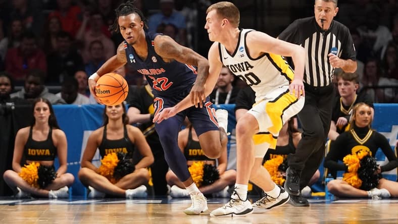 Mar 16, 2023; Birmingham, AL, USA; Auburn Tigers guard Allen Flanigan (22) is defended by Iowa Hawkeyes forward Payton Sandfort (20) during the second half in the first round of the 2023 NCAA Tournament at Legacy Arena. Mandatory Credit: Marvin Gentry-USA TODAY Sports