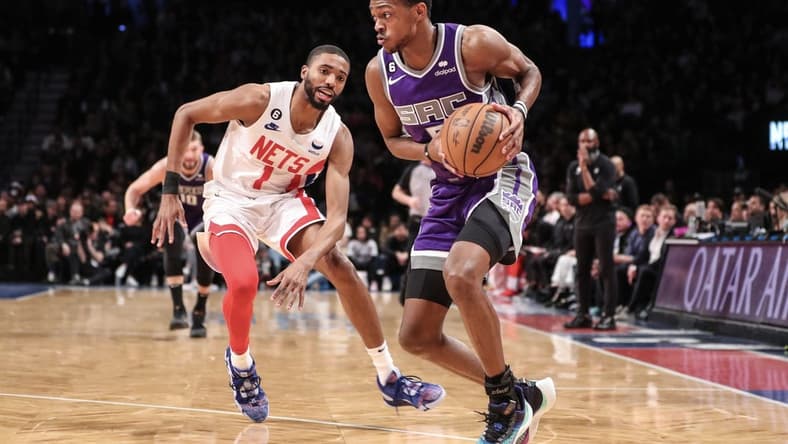 Mar 16, 2023; Brooklyn, New York, USA;  Sacramento Kings guard De'Aaron Fox (5) looks to drive past Brooklyn Nets forward Mikal Bridges (1) in the second quarter at Barclays Center. Mandatory Credit: Wendell Cruz-USA TODAY Sports