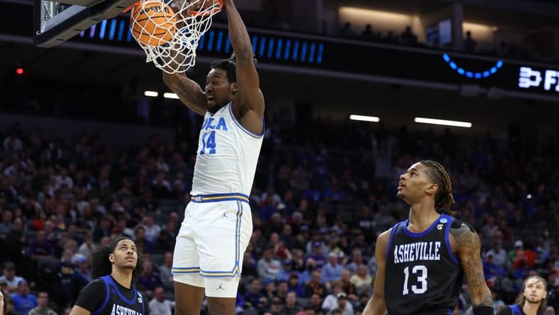Mar 16, 2023; Sacramento, CA, USA; UCLA Bruins forward/center Kenneth Nwuba (14) dunks against the UNC Asheville Bulldogs in the first half at Golden 1 Center. Mandatory Credit: Kelley L Cox-USA TODAY Sports