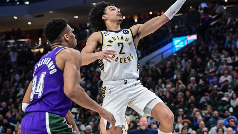 Mar 16, 2023; Milwaukee, Wisconsin, USA; Indiana Pacers guard Andrew Nembhard (2) takes a shot against Milwaukee Bucks forward Giannis Antetokounmpo (34) in the fourth quarter at Fiserv Forum. Mandatory Credit: Benny Sieu-USA TODAY Sports